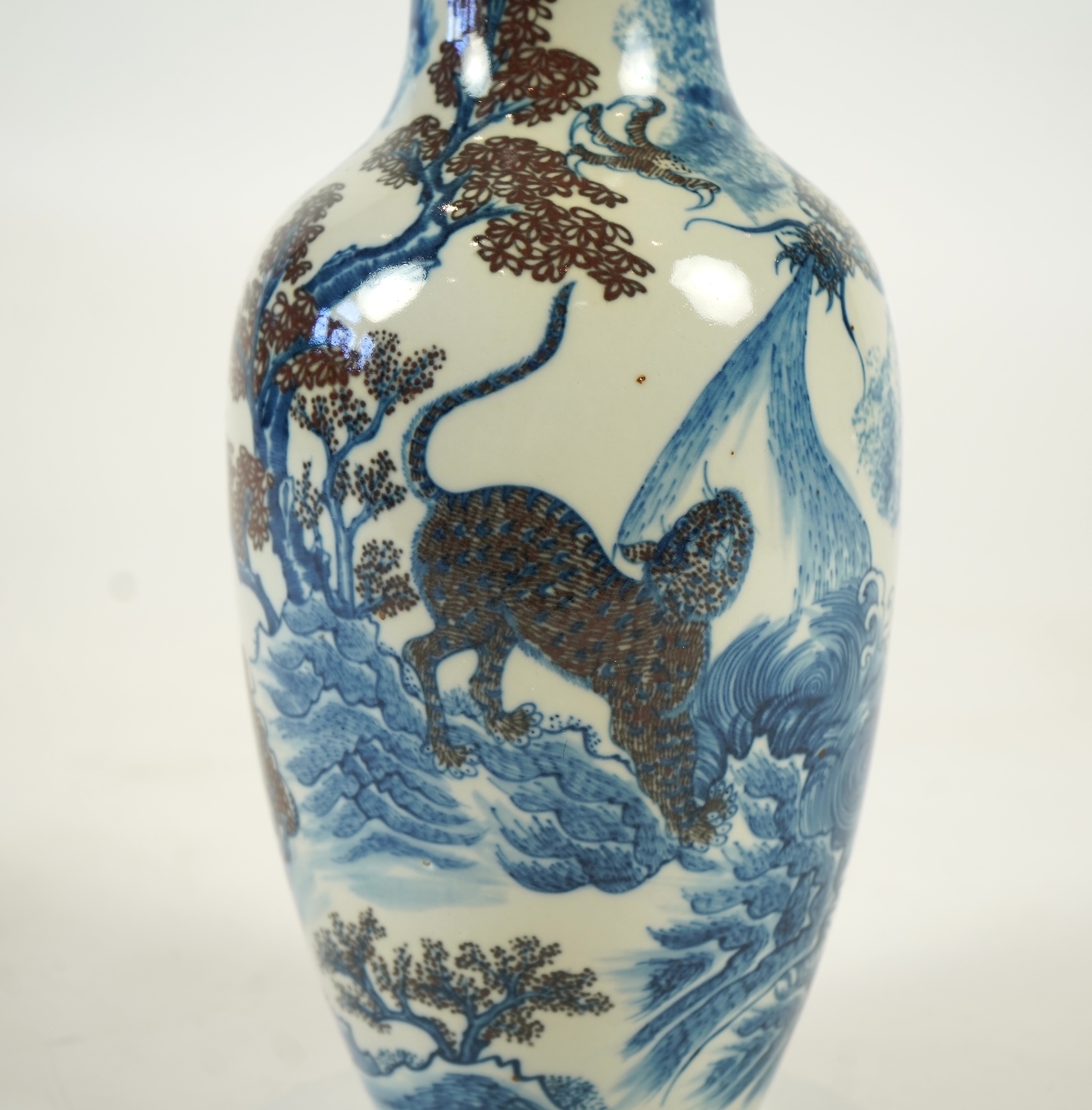 A Chinese underglaze blue and copper red ’dragon and tiger’ baluster vase, possibly 19th century